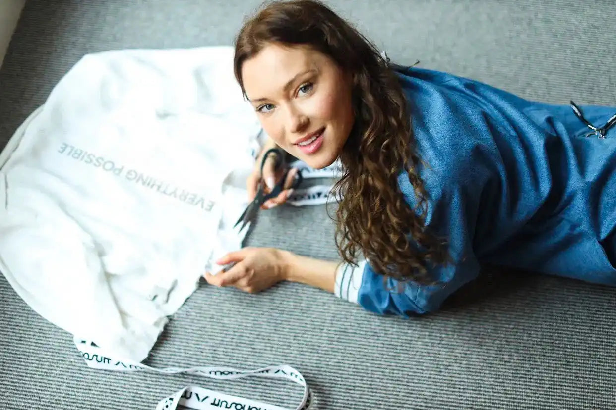 Someone relaxing on the floor while reading papers or documents.