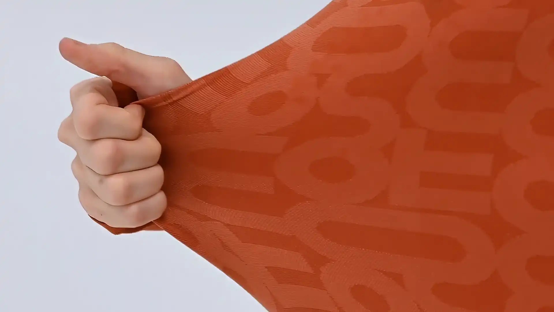 Stretching orange jumpsuit fabric