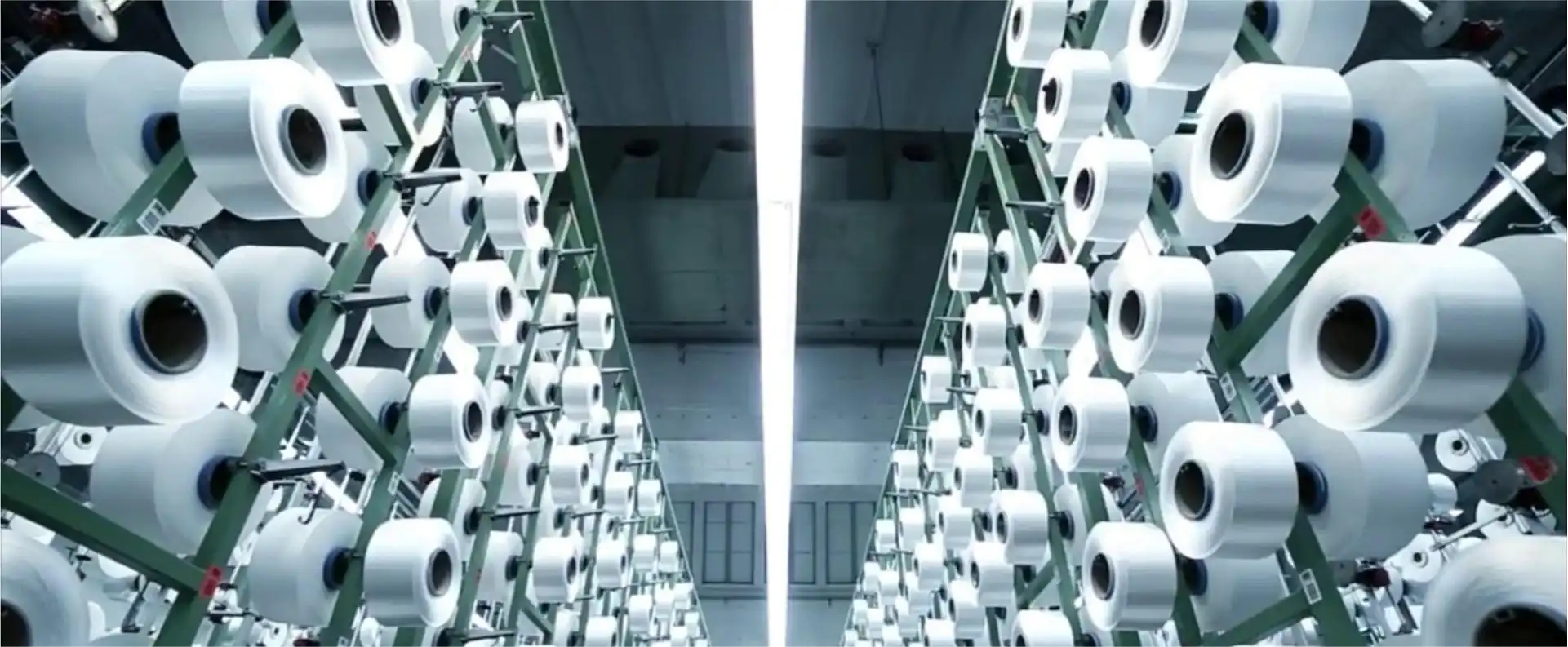 Rows of white textile spools