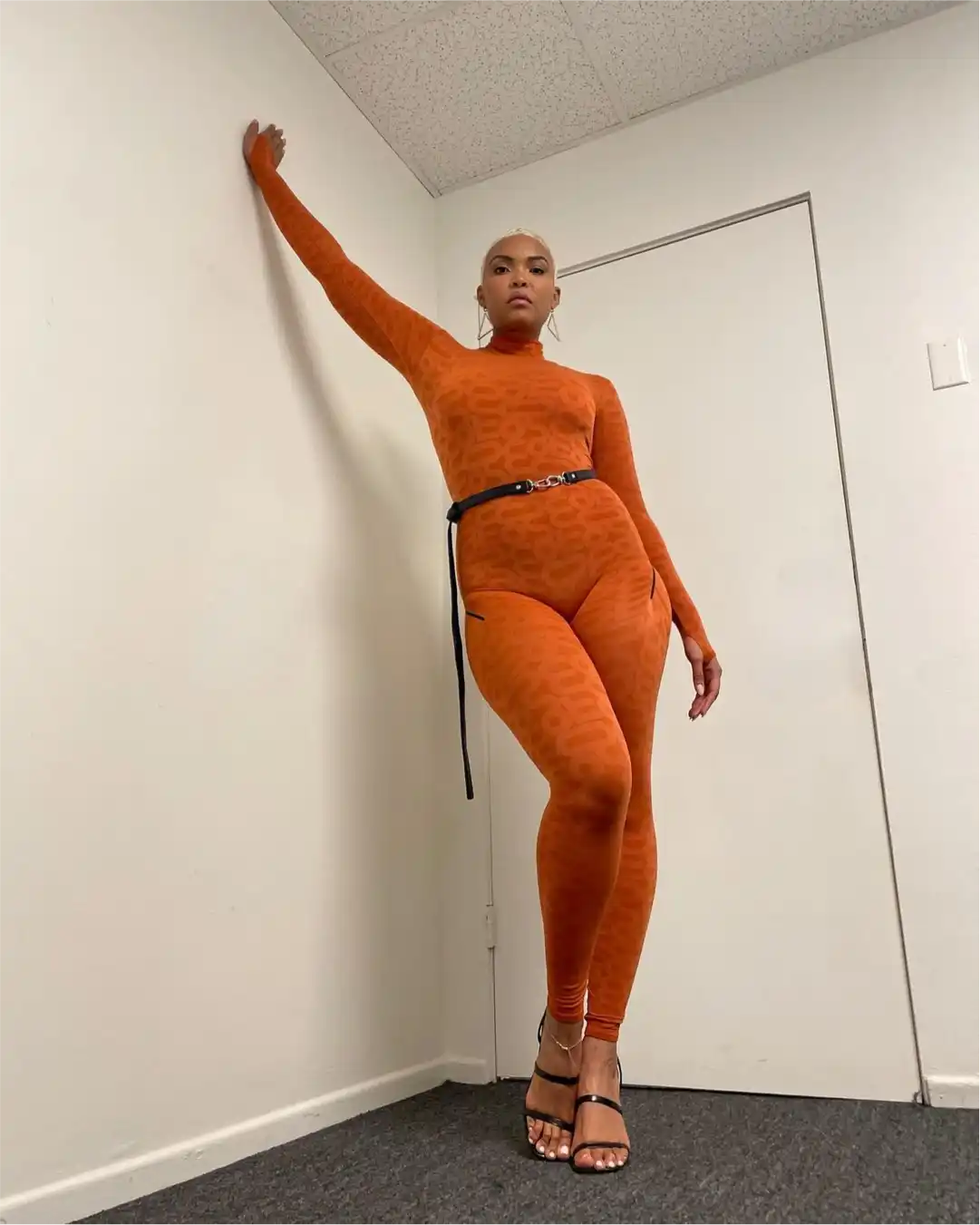 Woman in orange Monosuit with belt