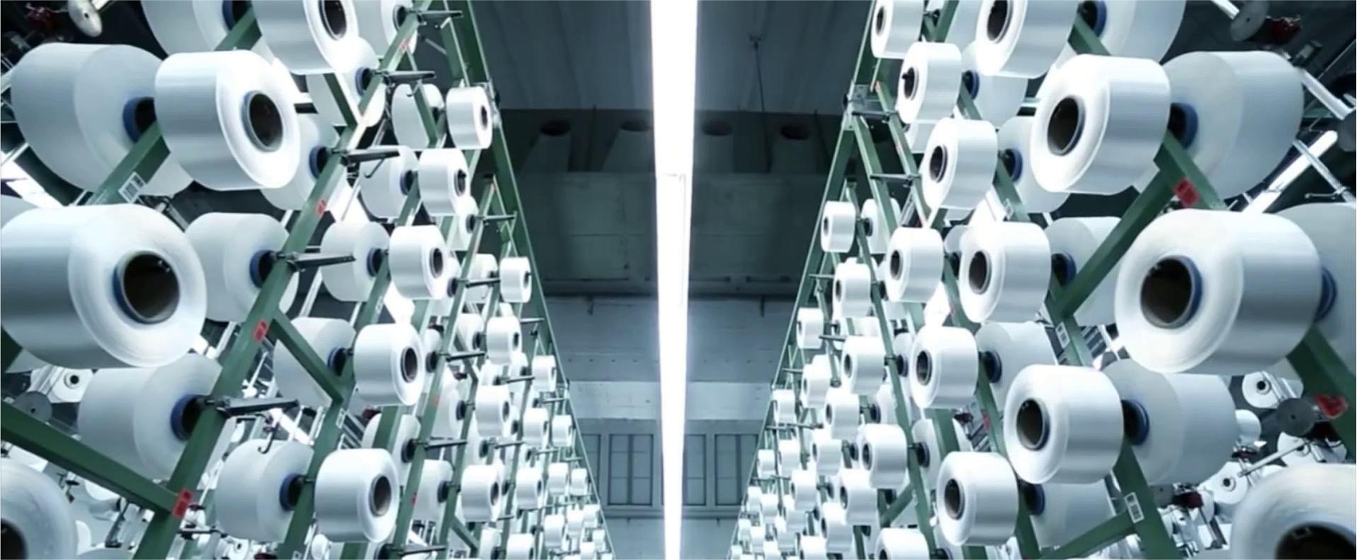 Rows of white textile spools